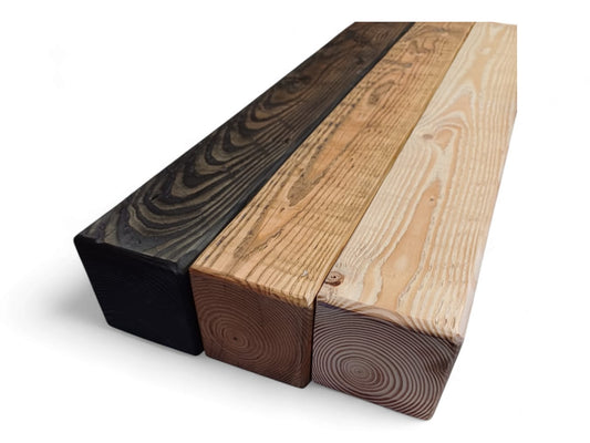 Three solid wood fireplace mantels side by side in dark, warm brown and light natural finishes.