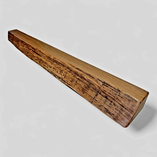 A slimline oak fireplace mantle with a natural wood grain finish, showing the unique patterns of the reclaimed wood.